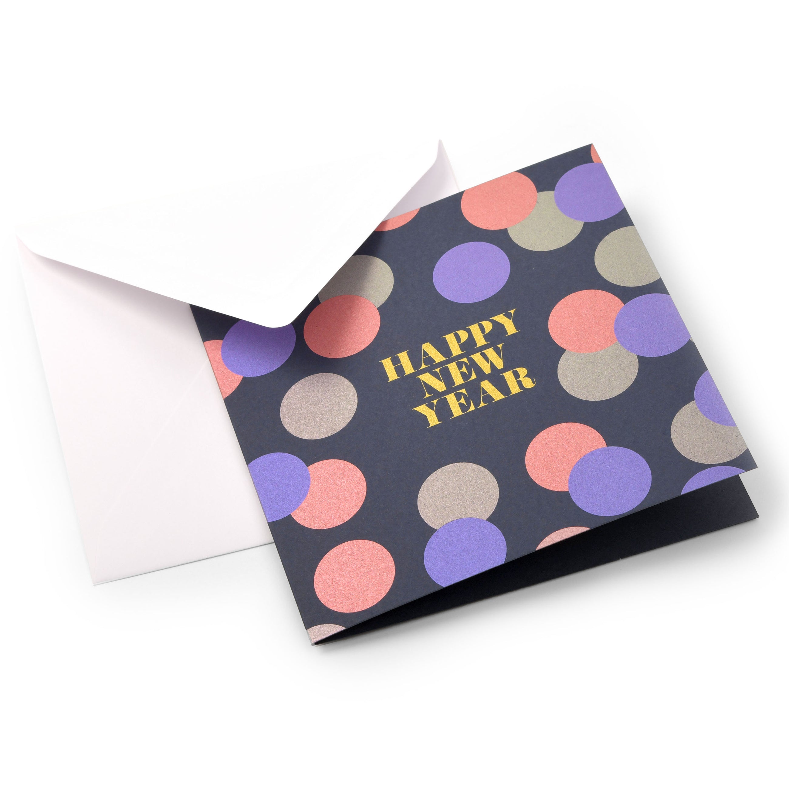 A dark blue New Year’s card decorated with colorful metallic confetti dots in purple, pink, and gold, featuring the text "HAPPY NEW YEAR" in bold gold lettering at the center, shown with a plain white envelope.