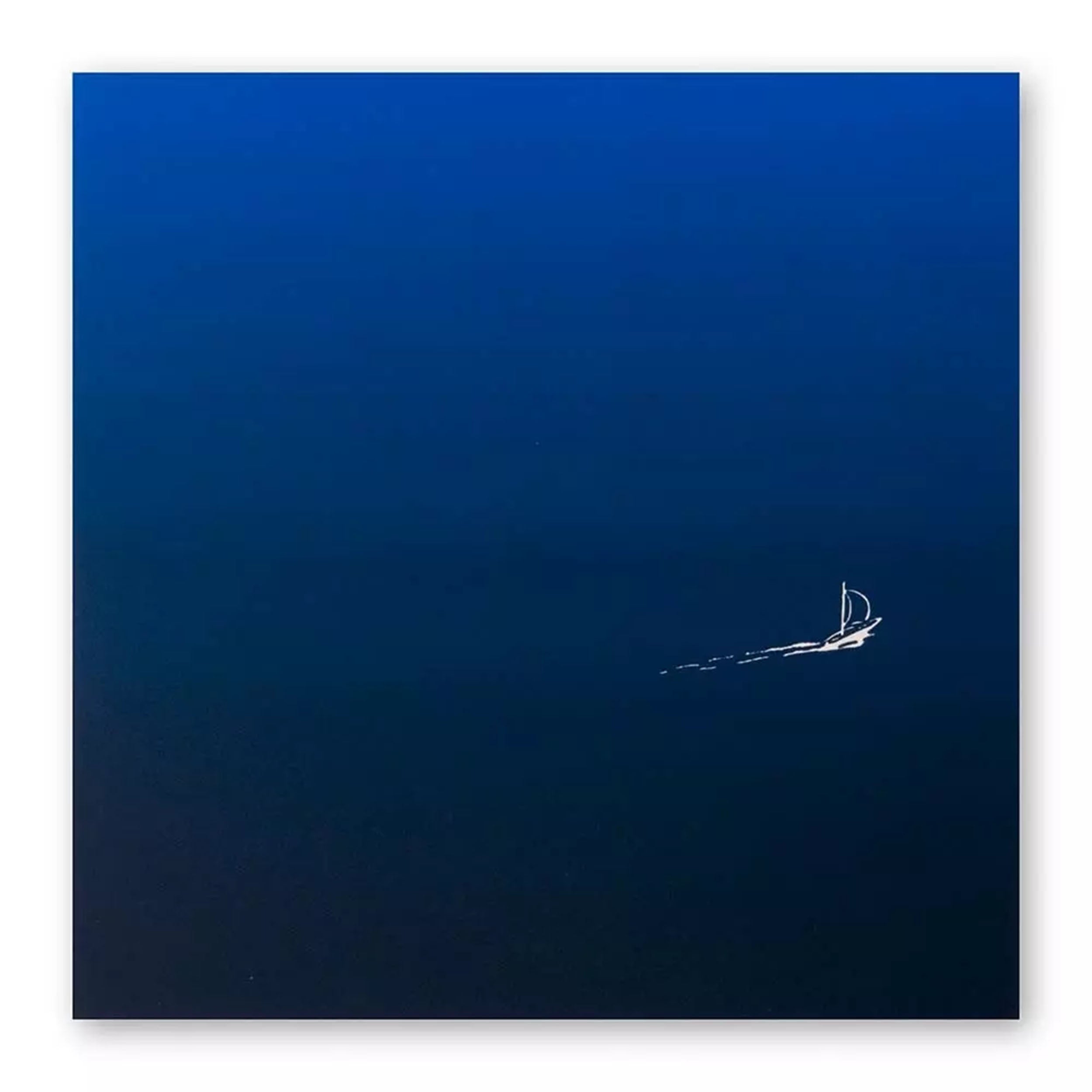 A minimalist greeting card with a deep blue gradient background, featuring a tiny white sailboat leaving a delicate trail across the open water.