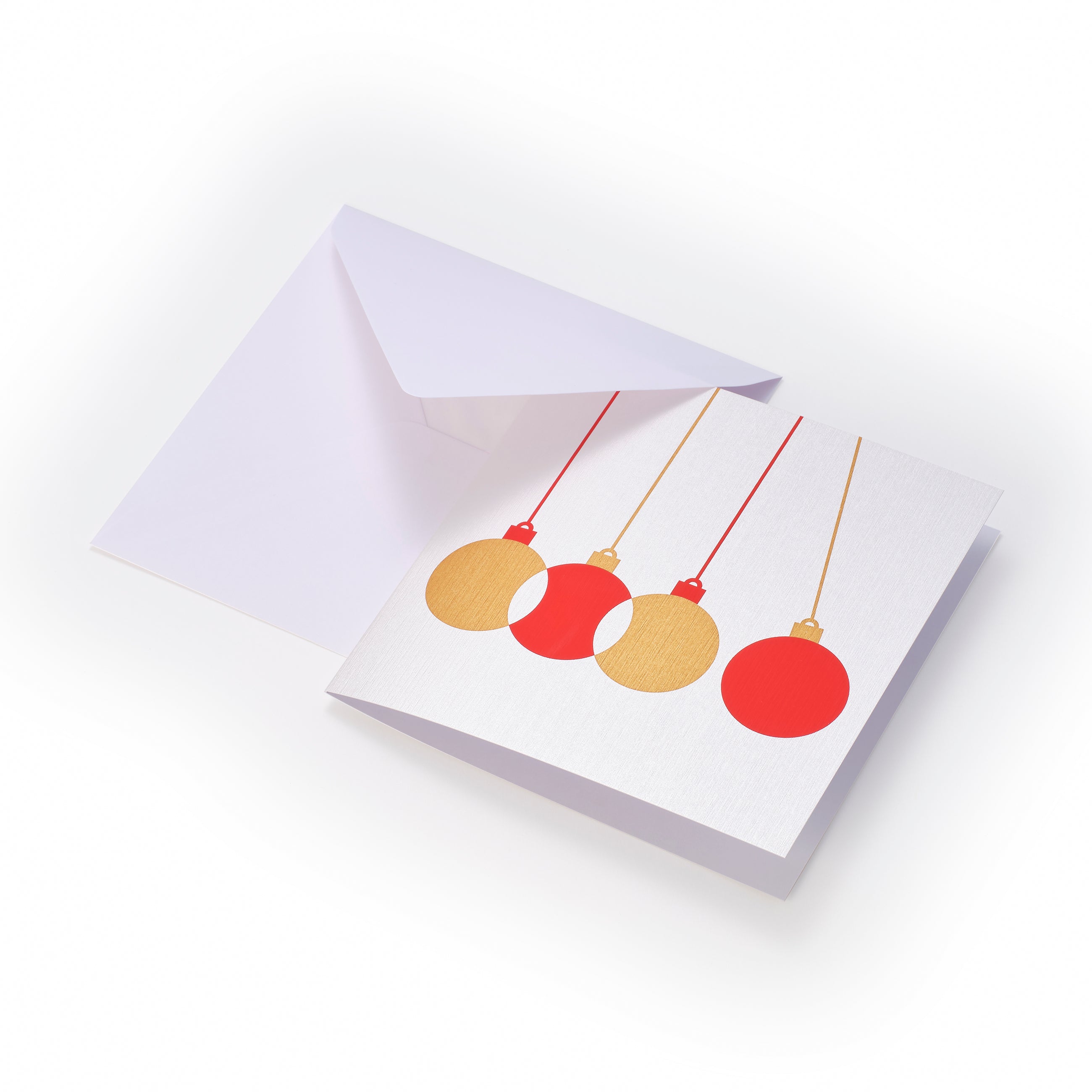 Minimalist Christmas card with four hanging ornaments in red and gold on a white textured background, paired with a white envelope.