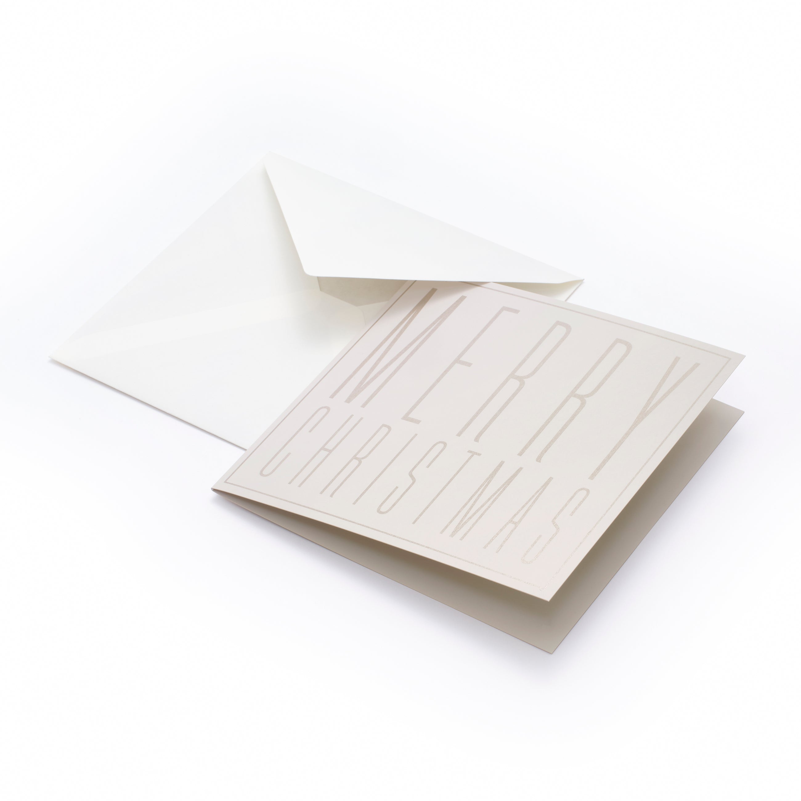 A square cream-colored Christmas card with embossed tall block letters spelling "MERRY CHRISTMAS," paired with a matching cream envelope.