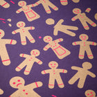 Wrapping paper with a festive pattern of golden gingerbread men and women scattered across a deep purple background, accented with small bright pink details.