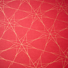 Wrapping paper with a festive pattern of fine golden star outlines scattered across a deep red background.