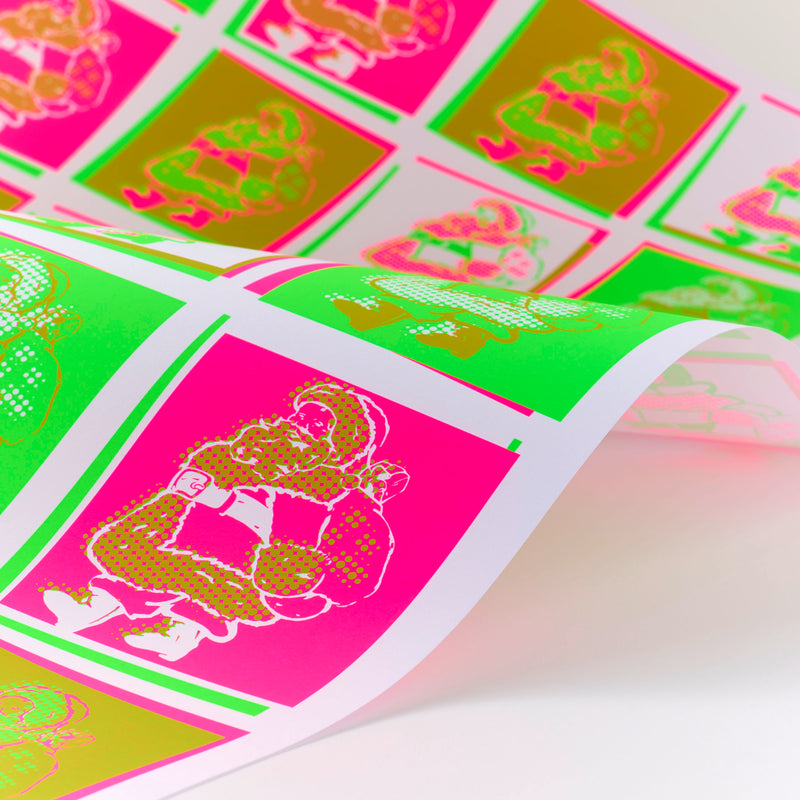 Sheet of wrapping paper printed with repeating Santa Claus illustrations in bright neon pink, green, and gold, shown curling slightly to display its texture and shine.