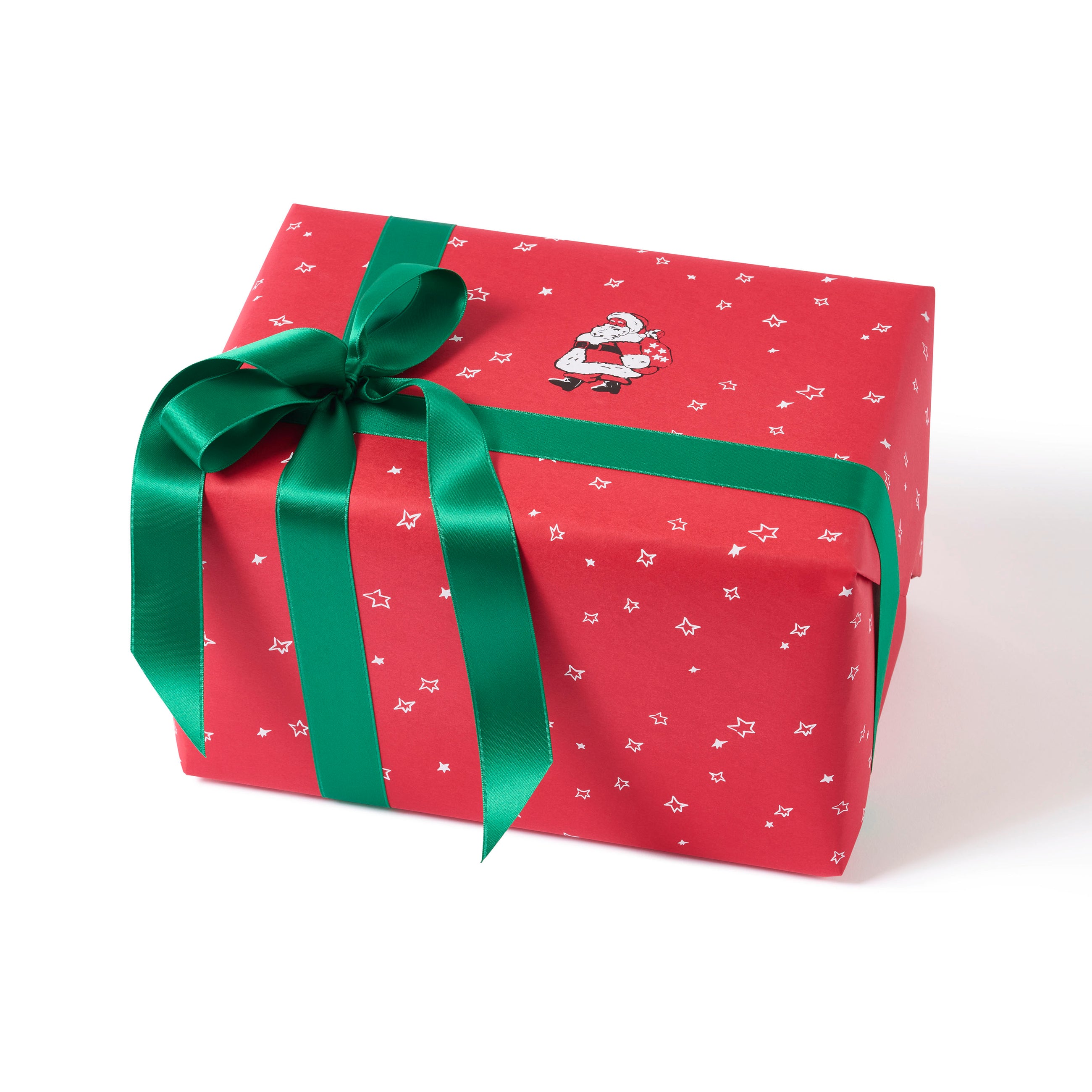 Wrapping paper with a festive pattern of a small illustrated Santa and white doodled stars on a cheerful red background, tied with a deep green ribbon.