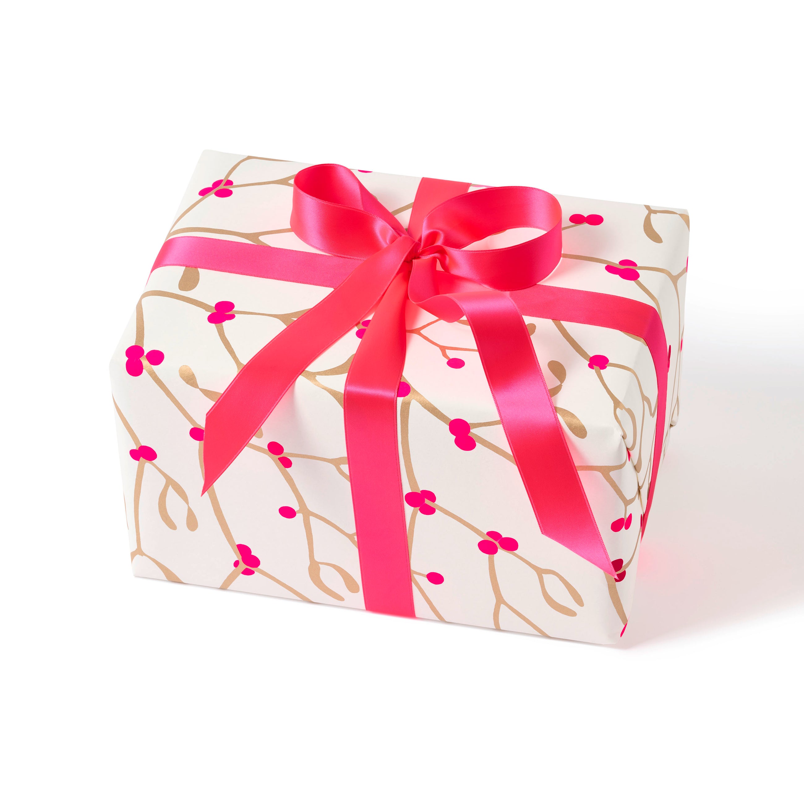Gift wrapped in paper with a festive pattern of golden mistletoe branches and vibrant pink berries, tied with a wide, glossy pink ribbon.