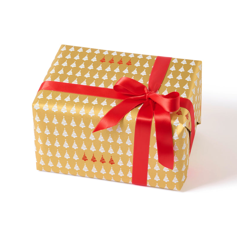 Wrapped gift in paper featuring a festive pattern of small white Christmas trees on a glowing gold background, with a bold red ribbon and a row of vivid red trees adding a cheerful contrast.