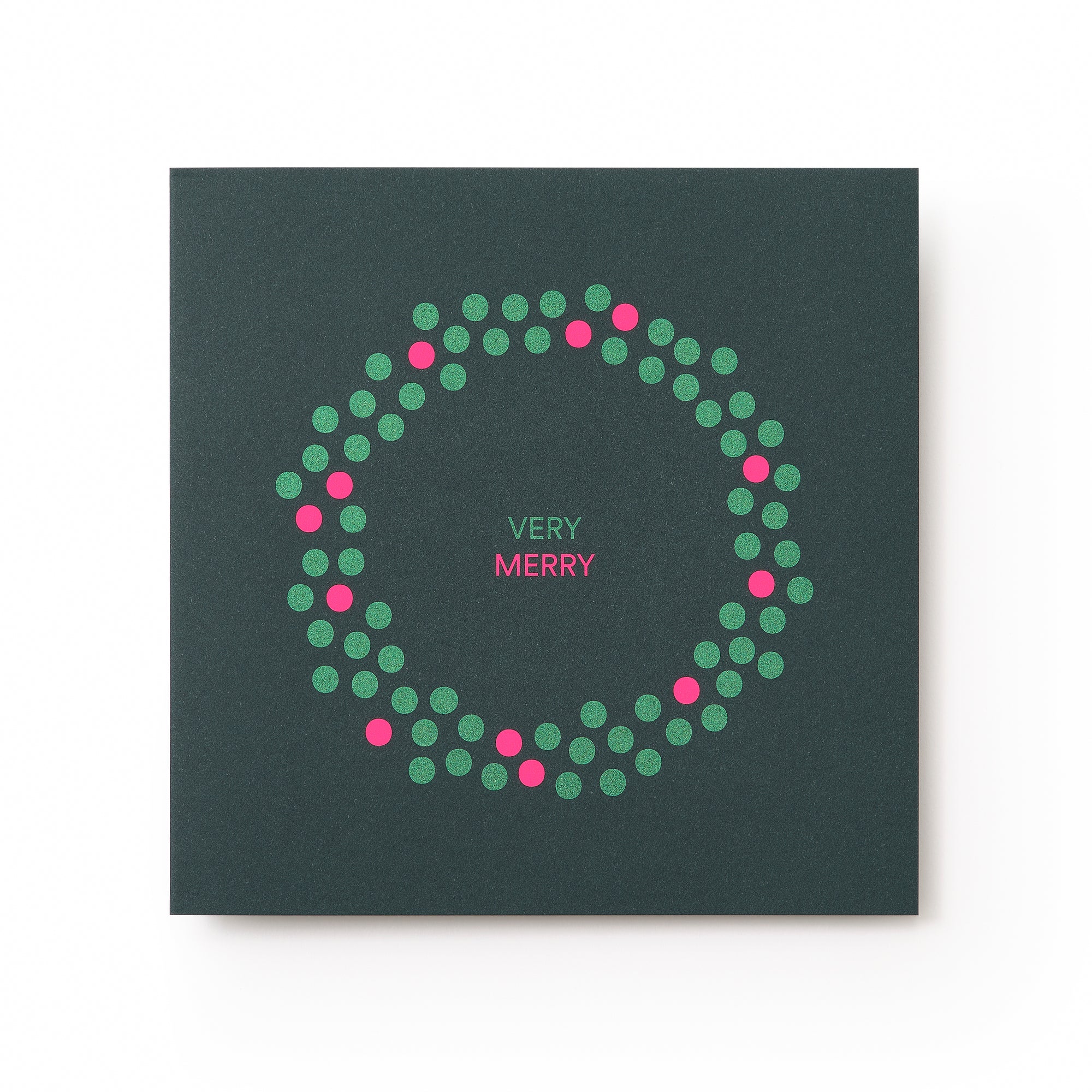 A dark green Christmas card with a minimalist wreath design made of green and pink dots, surrounding the text "VERY MERRY" in pink and white at the center.