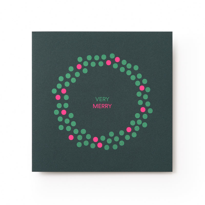 A dark green Christmas card with a minimalist wreath design made of green and pink dots, surrounding the text "VERY MERRY" in pink and white at the center.