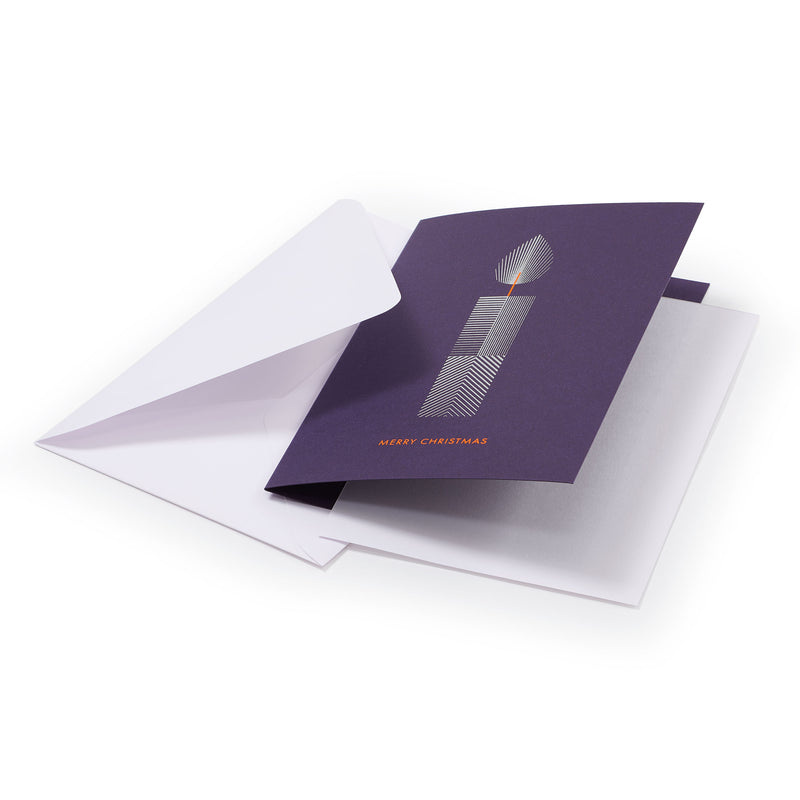 A purple Christmas card with a minimalist white candle design featuring geometric line patterns and an orange flame, the text "MERRY CHRISTMAS" in orange at the bottom, shown with a plain white envelope.