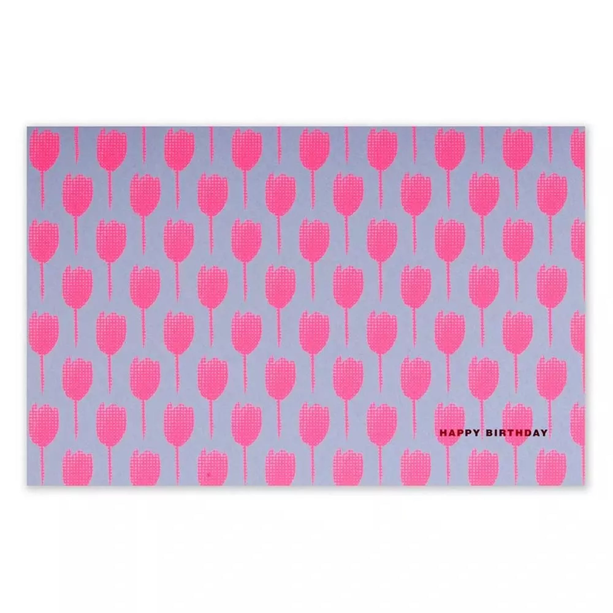 A rectangular greeting card with a lilac background, covered in a repeating pattern of bright pink tulip silhouettes, with “HAPPY BIRTHDAY” printed in small text in the corner.