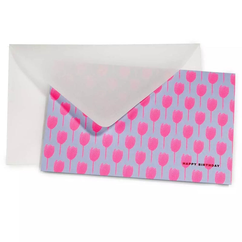 A transparent envelope with a greeting card partially tucked inside, featuring a repeating pattern of pink tulips and a small “HAPPY BIRTHDAY” detail on the front.