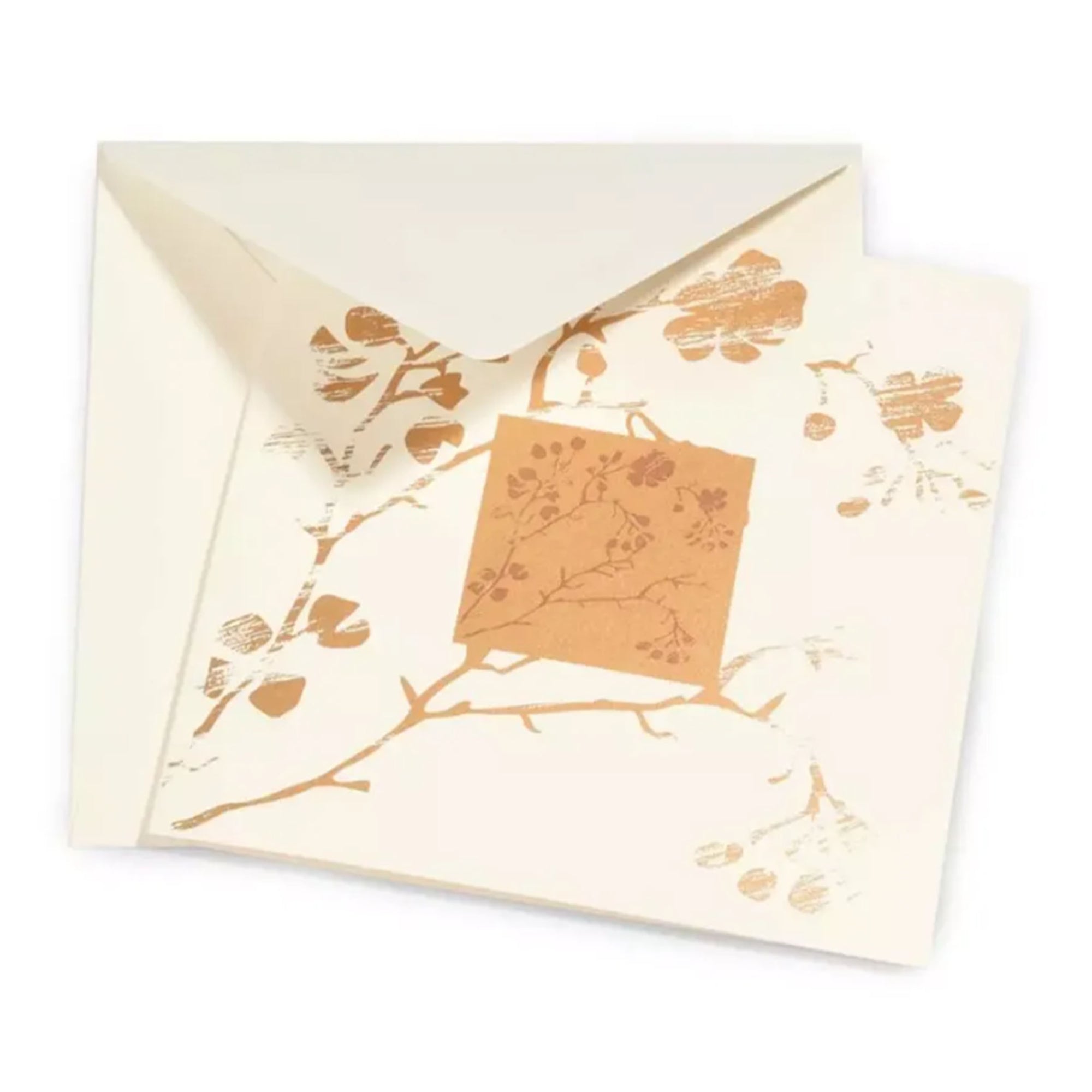 A refined greeting card with a soft cream background, adorned with delicate, metallic gold botanical prints of branches, leaves, and cherry blossoms arranged around a central square motif, partially tucked into a matching envelope.
