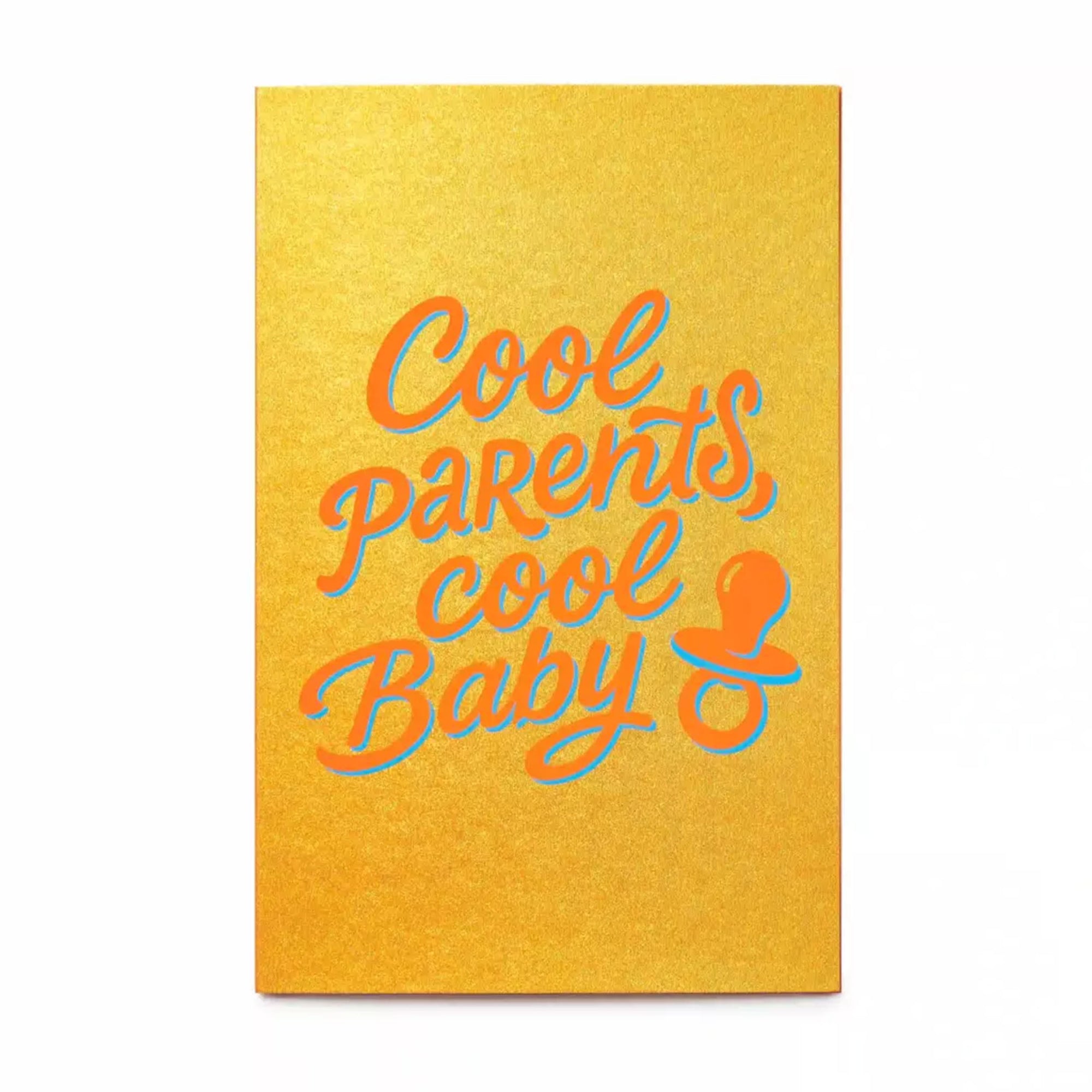 A vibrant greeting card with a warm golden-yellow background, featuring playful script lettering in bright orange with a soft blue shadow reading “Cool parents, cool baby,” alongside a small pacifier icon.
