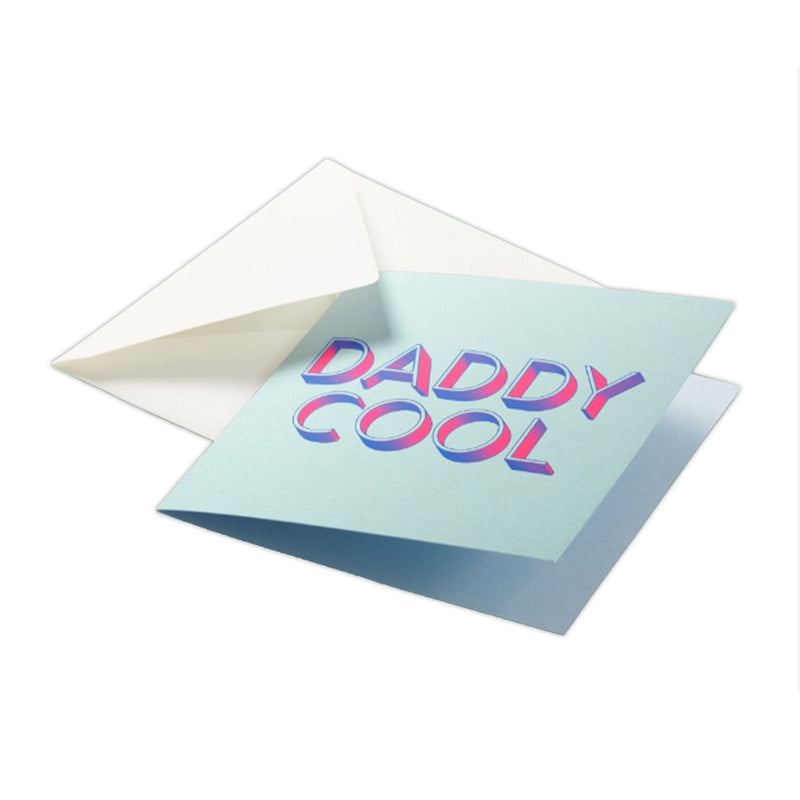 A modern greeting card with a soft mint background, featuring bold “DADDY COOL” lettering in a vibrant pink-to-blue gradient with a retro 3D effect, tucked into a white envelope.
