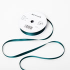 A spool of satin ribbon in hunter green, narrow in width, partially unrolled, with a white label on top reading “BETHGE” and product details including width, length, and material.