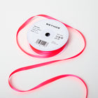 A spool of satin ribbon in neon pink, narrow in width, partially unrolled, with a white label on top reading “BETHGE” and product details including width, length, and material.
