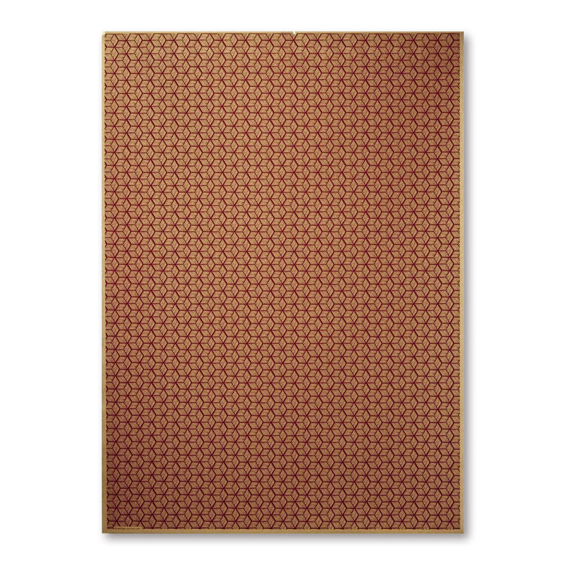 A warm-toned wrapping paper covered in a tight geometric pattern of small, repeating hexagon-like shapes in gold and reddish-brown.