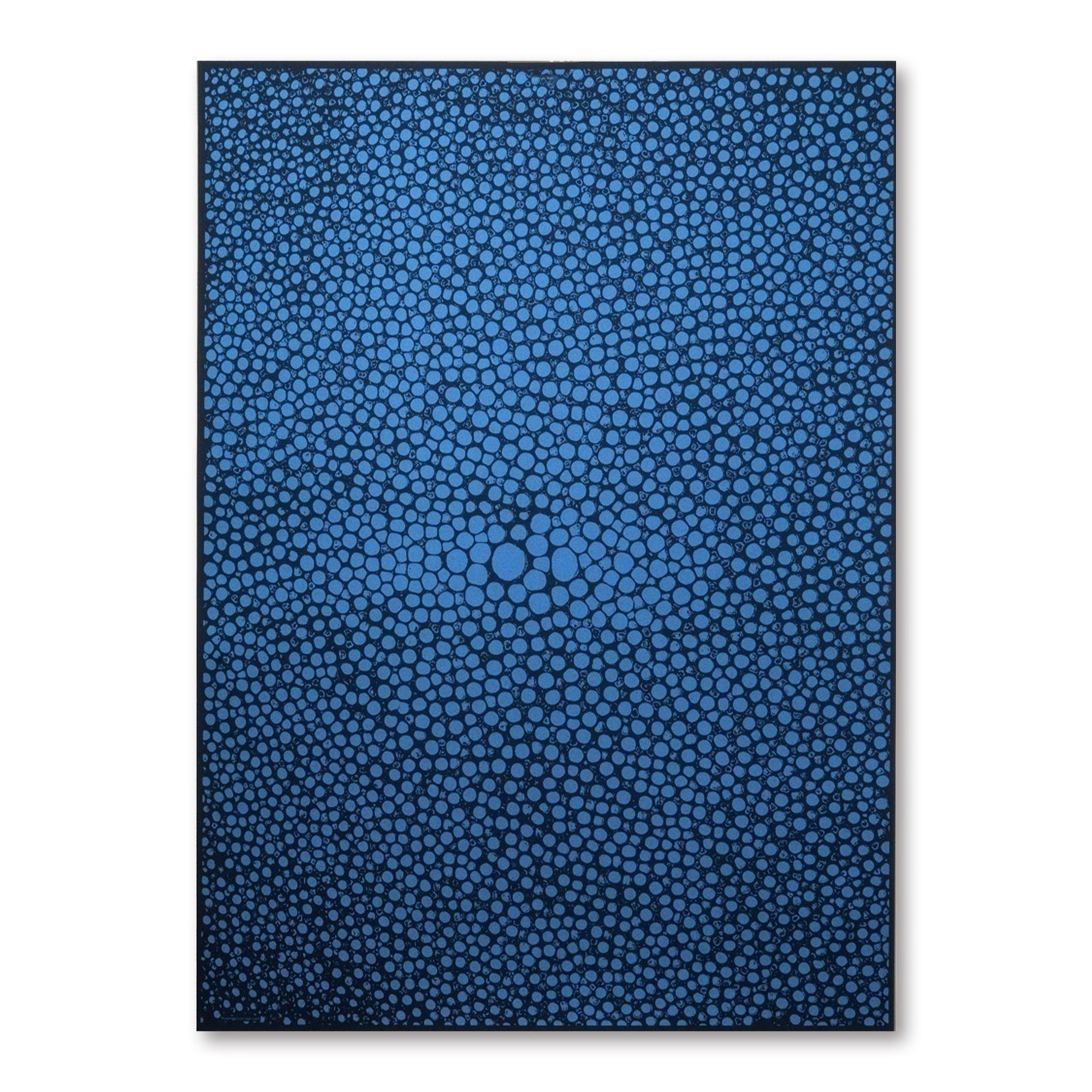 A dark blue gift wrap covered with dense, organic dot shapes in lighter blue, creating a pebble-like, flowing pattern across the surface.