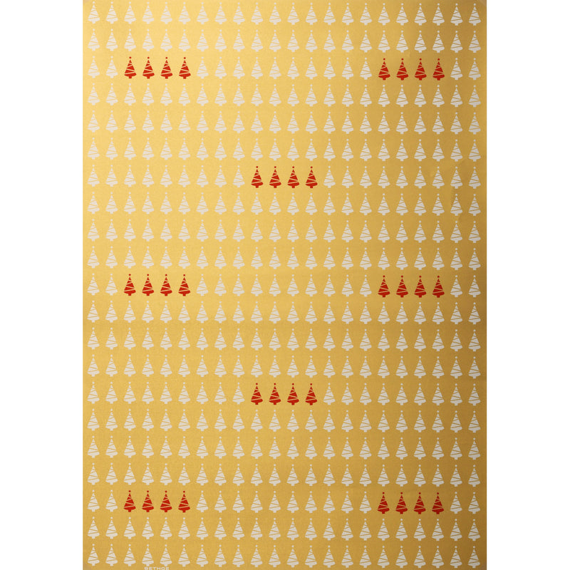 Gold wrapping paper patterned with rows of small white Christmas trees and clusters of red trees scattered throughout.