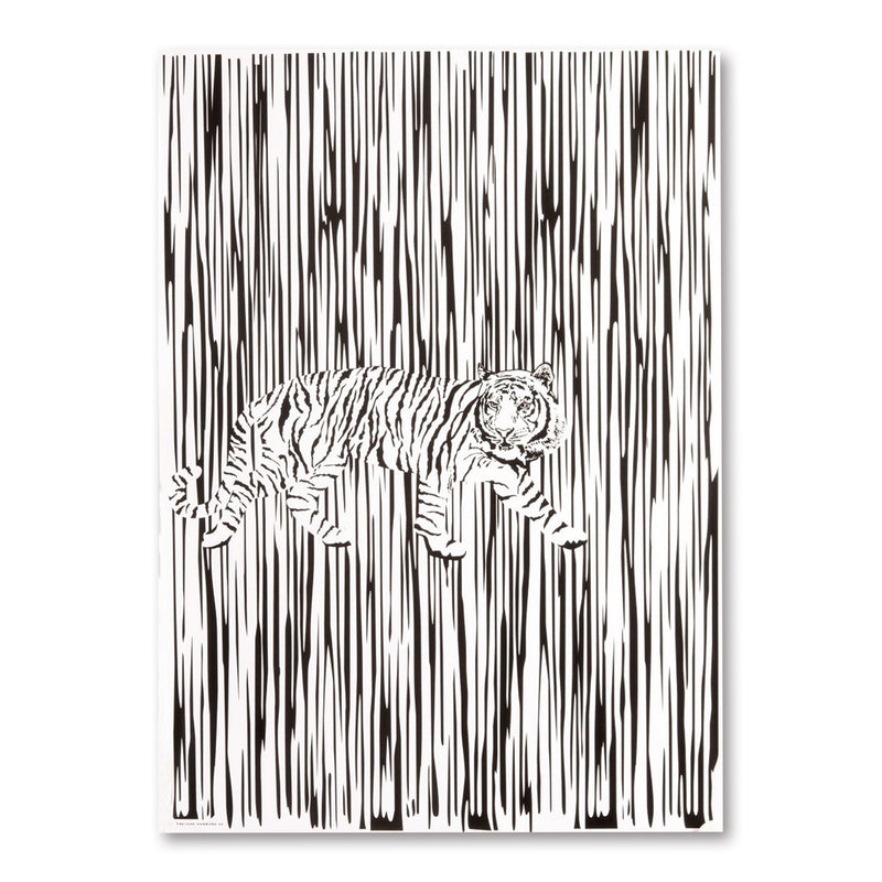 A black-and-white wrapping paper design showing a tiger walking across vertical brushstroke lines, with the animal centered against a graphic striped background.