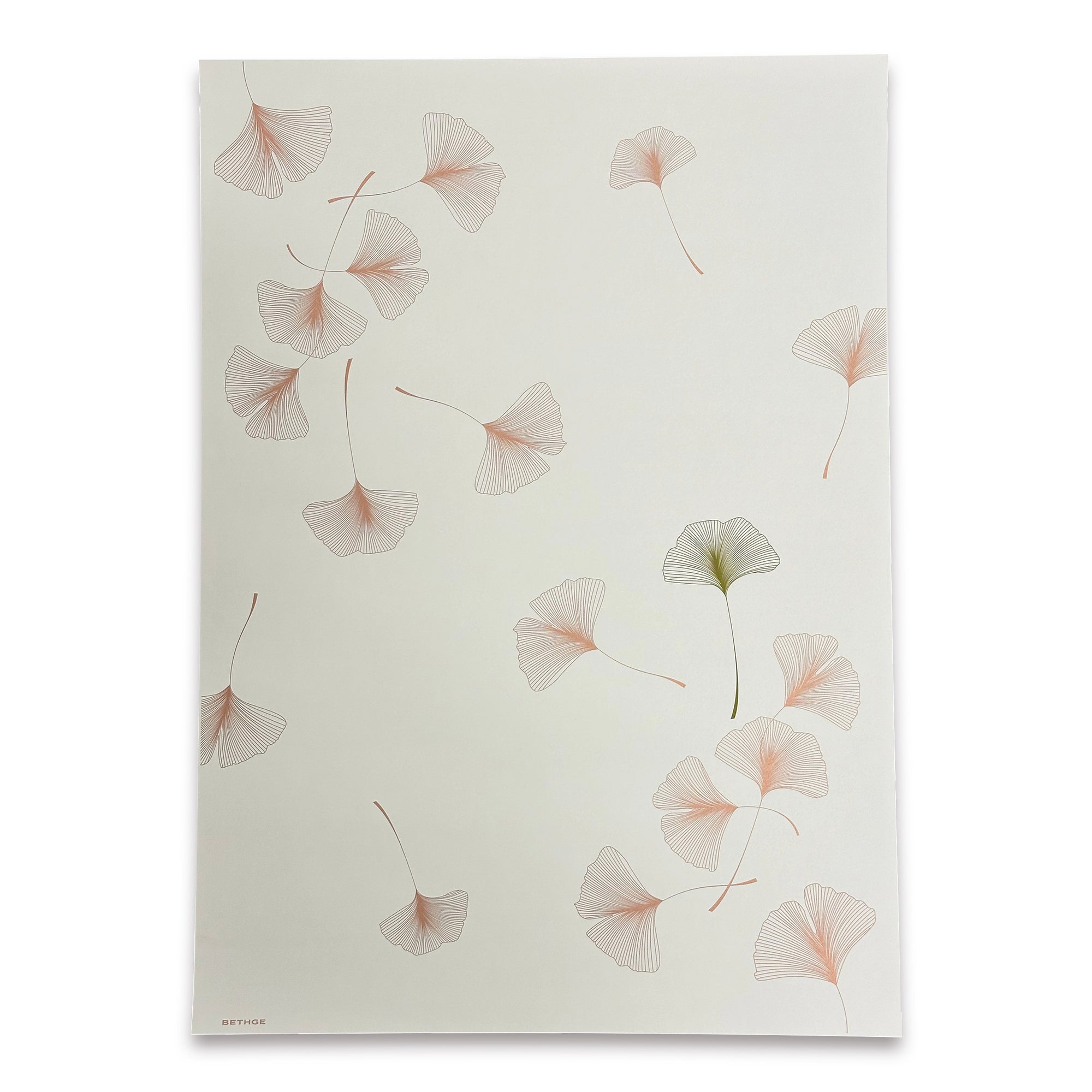 A warm ivory wrapping paper adorned with gently drifting ginkgo leaves illustrated in fine linework, highlighted by soft bronze and olive tones.