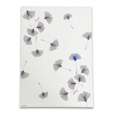 A soft ivory wrapping paper scattered with delicate ginkgo leaves drawn in fine, flowing lines, featuring subtle accents in muted violet and cool blue tones.