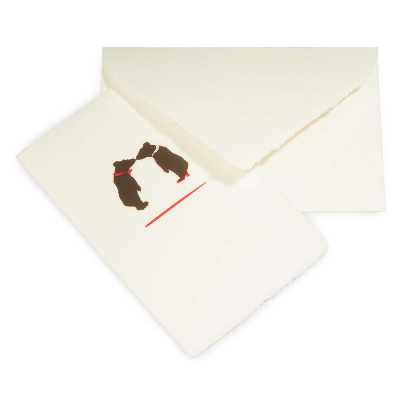 A folded greeting card and envelope show a small illustration of two bears touching noses on handmade paper with deckled-edges.