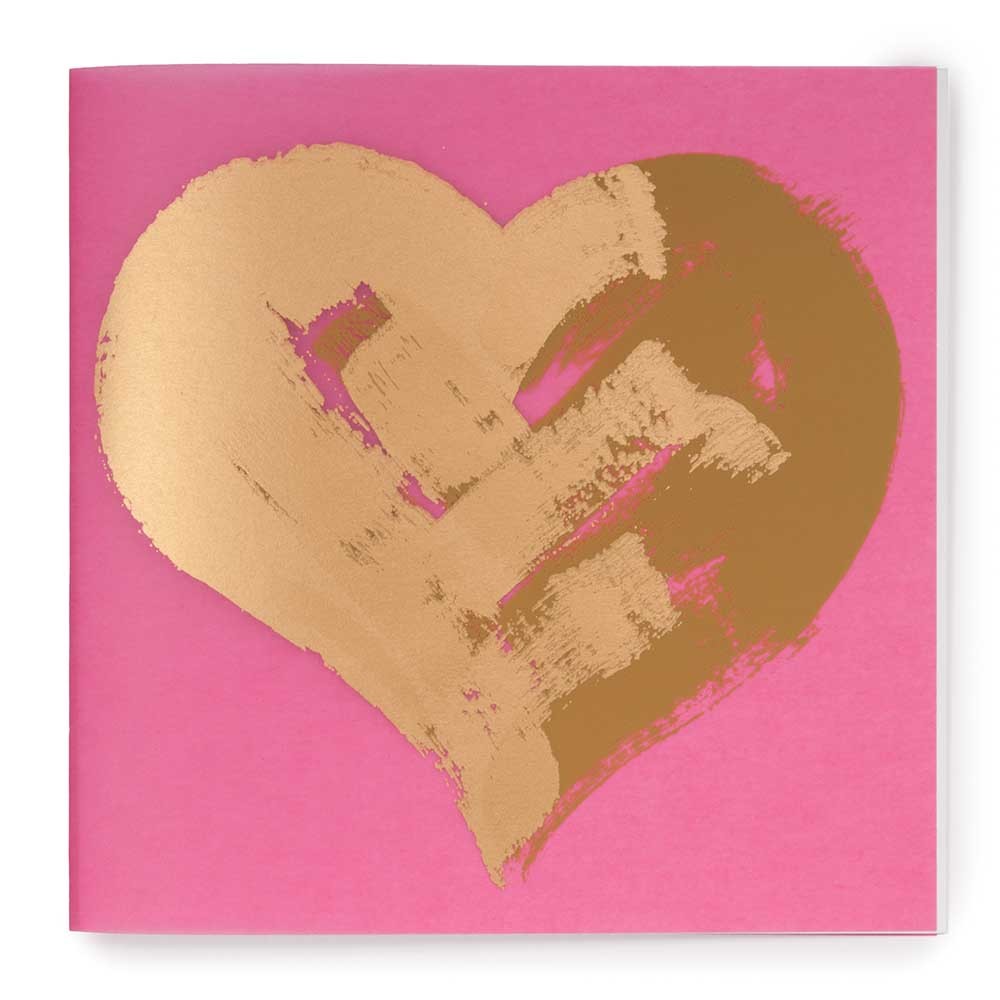 Greeting card with a saturated pink background, showcasing a large abstract gold heart with rough, painterly edges, presented straight-on against a clean white backdrop.