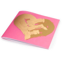 Greeting card with a bold pink background and a centered gold heart painted in broad, textured strokes, photographed flat to highlight the metallic sheen and minimalist design.