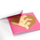 Greeting card with a vibrant pink background, featuring a large hand-painted gold heart motif with expressive brush strokes, shown partially tucked into a white envelope.
