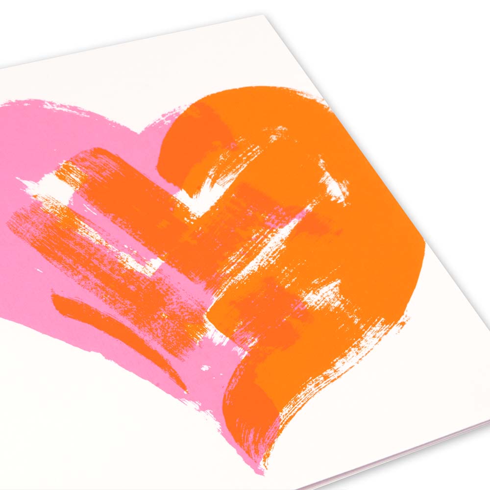 Greeting card with an expressive, hand-painted heart in overlapping neon pink and bright orange brushstrokes on a clean white background, shown as a close-up detail highlighting the textured paint effect.
