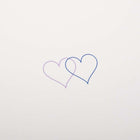 Close up of an ivory greeting card with two small overlapping hearts in blue and lilac set against a clean, minimal background.