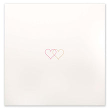 An ivory greeting card shown flat with two small overlapping hearts in pink and gold set against a clean, minimal background.