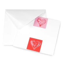 Greeting card with a minimalist design, featuring two contrasting heart motifs—one light pink on red and one red on pink—shown partially inserted into white envelopes.