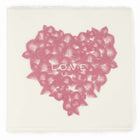 Greeting card with a refined artisanal style, featuring a soft pink feather-pattern heart centered on deckle-edged cream paper with the word “LOVE” subtly printed in white across the middle.