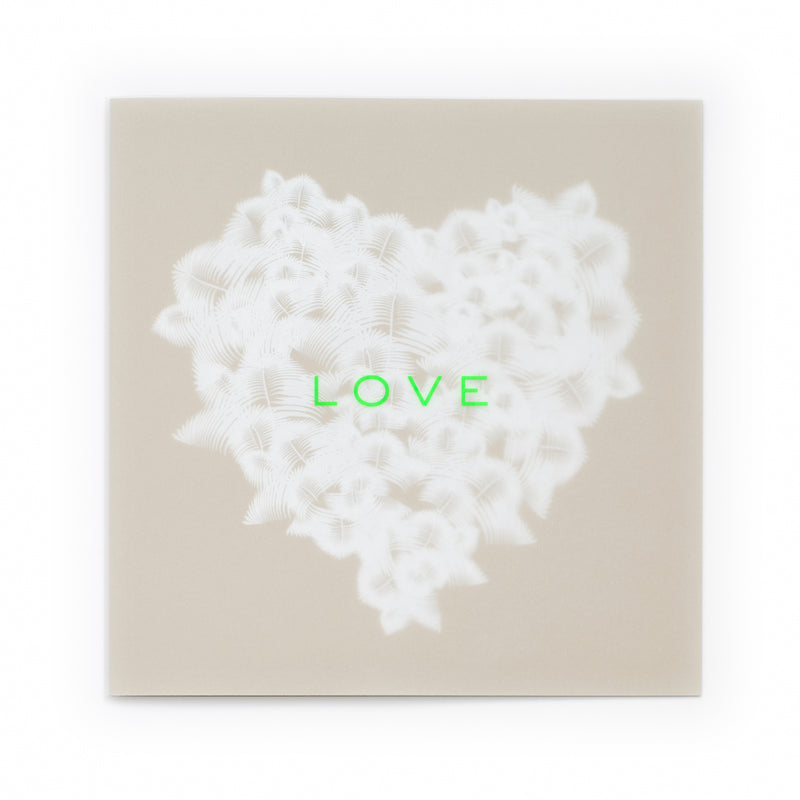Greeting card with an elegant, understated design, featuring a textured white feather heart centered on a warm beige background, accented by bright neon-green “LOVE” text, shown flat against a clean white backdrop.