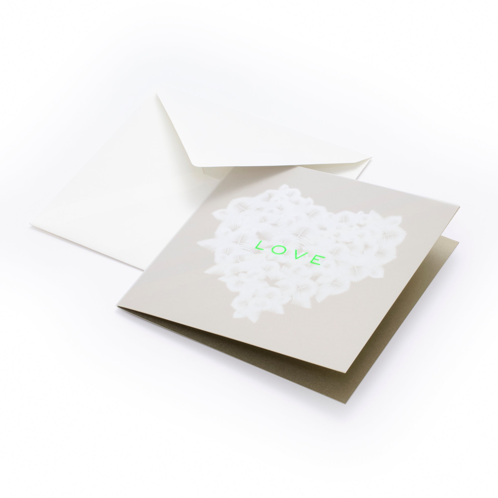 Greeting card with a refined, minimalist design, featuring a soft beige background and a heart formed from delicate white feather-like textures, with the word “LOVE” in subtle neon green at the center, shown partially open with a matching white envelope behind it.