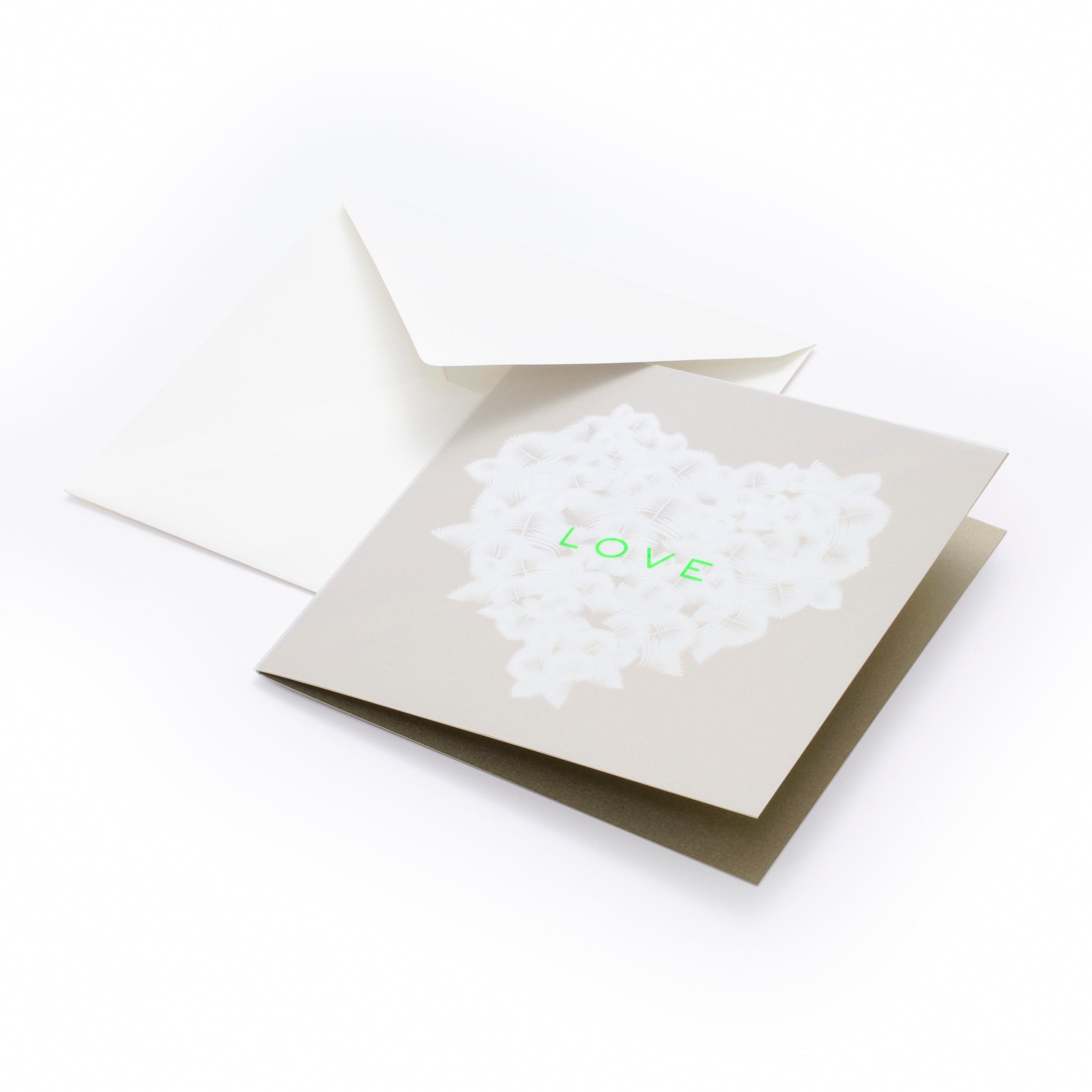 Greeting card with a refined, minimalist design, featuring a soft beige background and a heart formed from delicate white feather-like textures, with the word “LOVE” in subtle neon green at the center, shown partially open with a matching white envelope behind it.