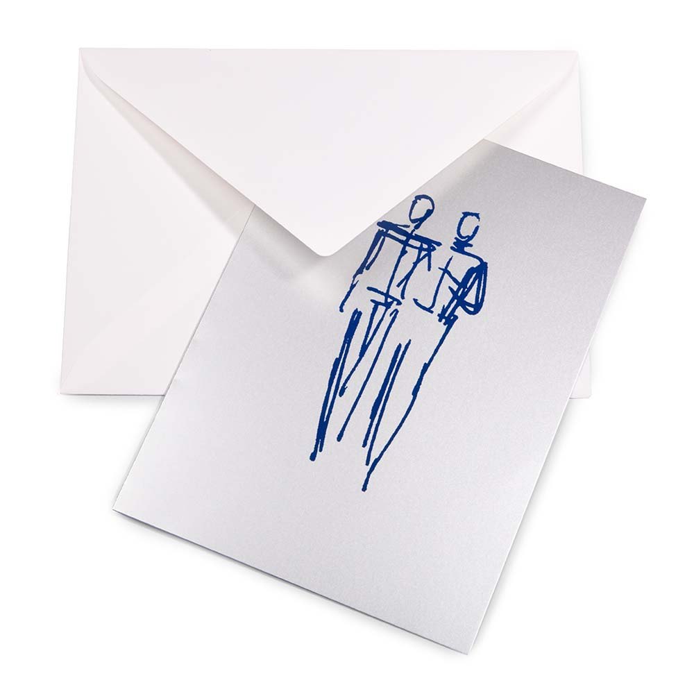A silver greeting card partly pulled from a white envelope, showing a loose blue line drawing of two men standing side by side.