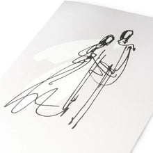 A close-up view of a pearly white card with a black, flowing line illustration of two figures leaning toward each other.