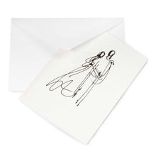 A pearlescent white greeting card shown partly pulled from a white envelope, featuring a fine black line drawing of a couple in an abstract, sketch-like style.