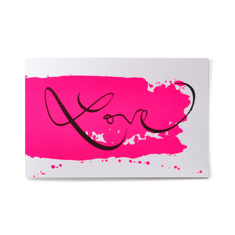 A white greeting card shown flat, centered with a bright pink brushstroke and the word “Love” written in smooth black calligraphic script.