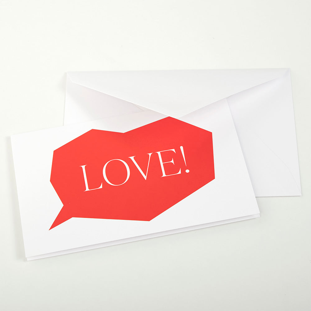 Greeting card with a bold red speech-bubble shape on a white background, featuring the word “LOVE!” in elegant white lettering, partially tucked into a matching white envelope.