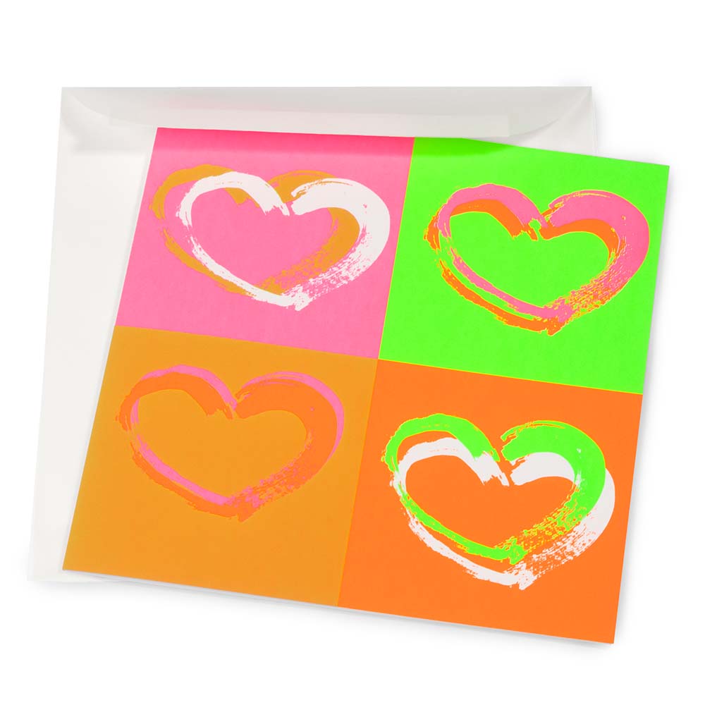 Wrapping paper–style greeting card with four expressive brushstroke hearts arranged in a pop-art grid, set on bright neon backgrounds in pink, green, orange, and coral tones, shown partially inside a white envelope.