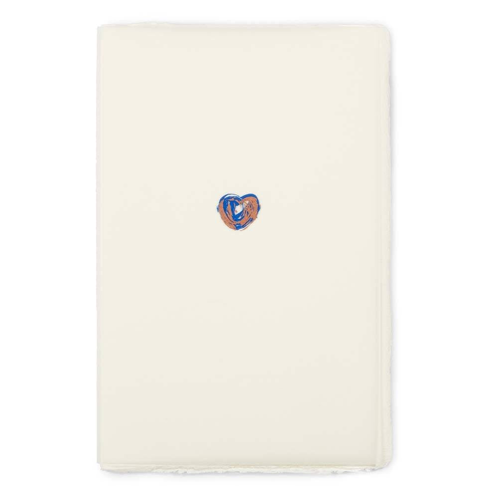 Greeting card with a minimalist design, featuring a small hand-painted heart in blue and copper tones centered on vertically oriented cream handmade paper, shown flat with deckled-edges.