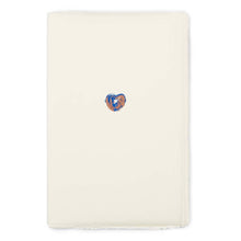 Greeting card with a minimalist design, featuring a small hand-painted heart in blue and copper tones centered on vertically oriented cream handmade paper, shown flat with deckled-edges.