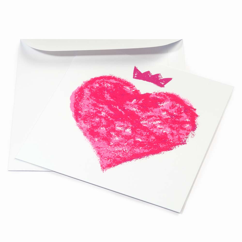 Greeting card with a bold, expressive design, featuring a hand-painted neon-pink heart topped with a small crown on a clean white background, shown slightly angled with a white envelope behind it.