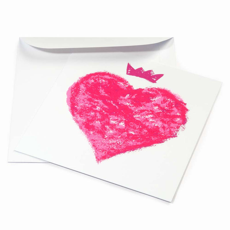 Greeting card with a bold, expressive design, featuring a hand-painted neon-pink heart topped with a small crown on a clean white background, shown slightly angled with a white envelope behind it.
