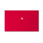 A bright red greeting card featuring a small white rose with a thin black stem printed near the center against the smooth red surface.