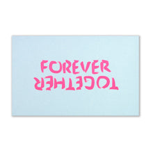 Forever Together greeting card laid flat on a white background, featuring large neon pink hand-painted lettering reading “FOREVER TOGETHER” against a soft light blue surface.